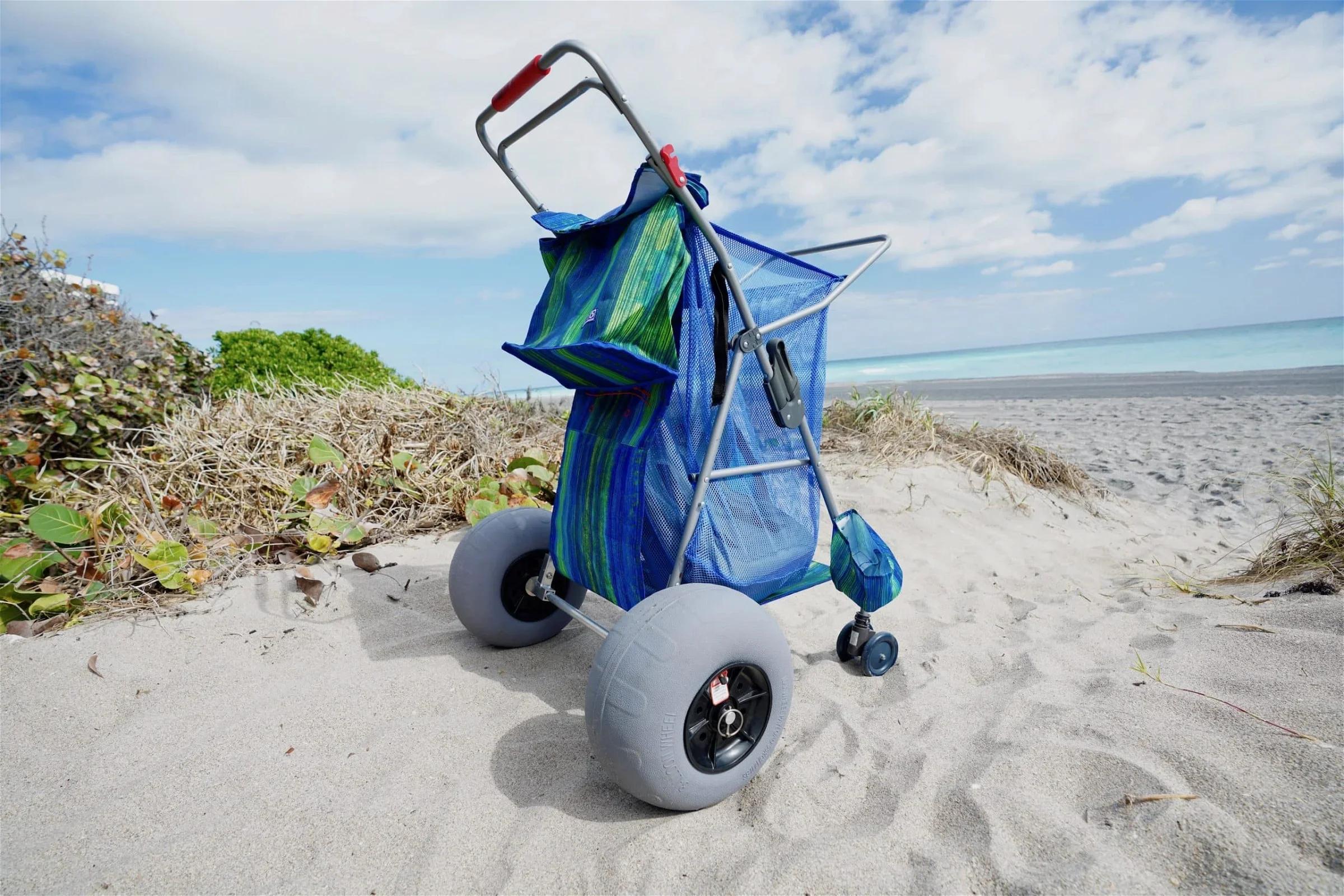 A cart with the 11.8″ balloon beach tire Wonder Wheeler Conversion Kit  on the sand.