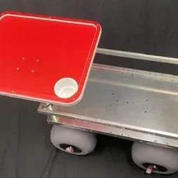 A red and white tabletop with cupholders, attached to a Kahuna Wagon with beach balloon tires.