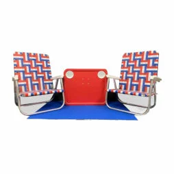 Two nostalgic red, white and blue folding beach chairs, sitting on a royal blue deck mat with a red wagon tabletop in between.